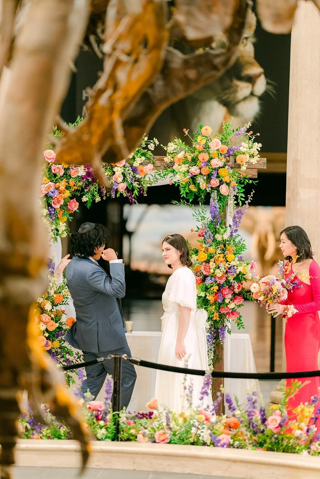 The ceremony framed by a dinosaur skeleton in the foreground