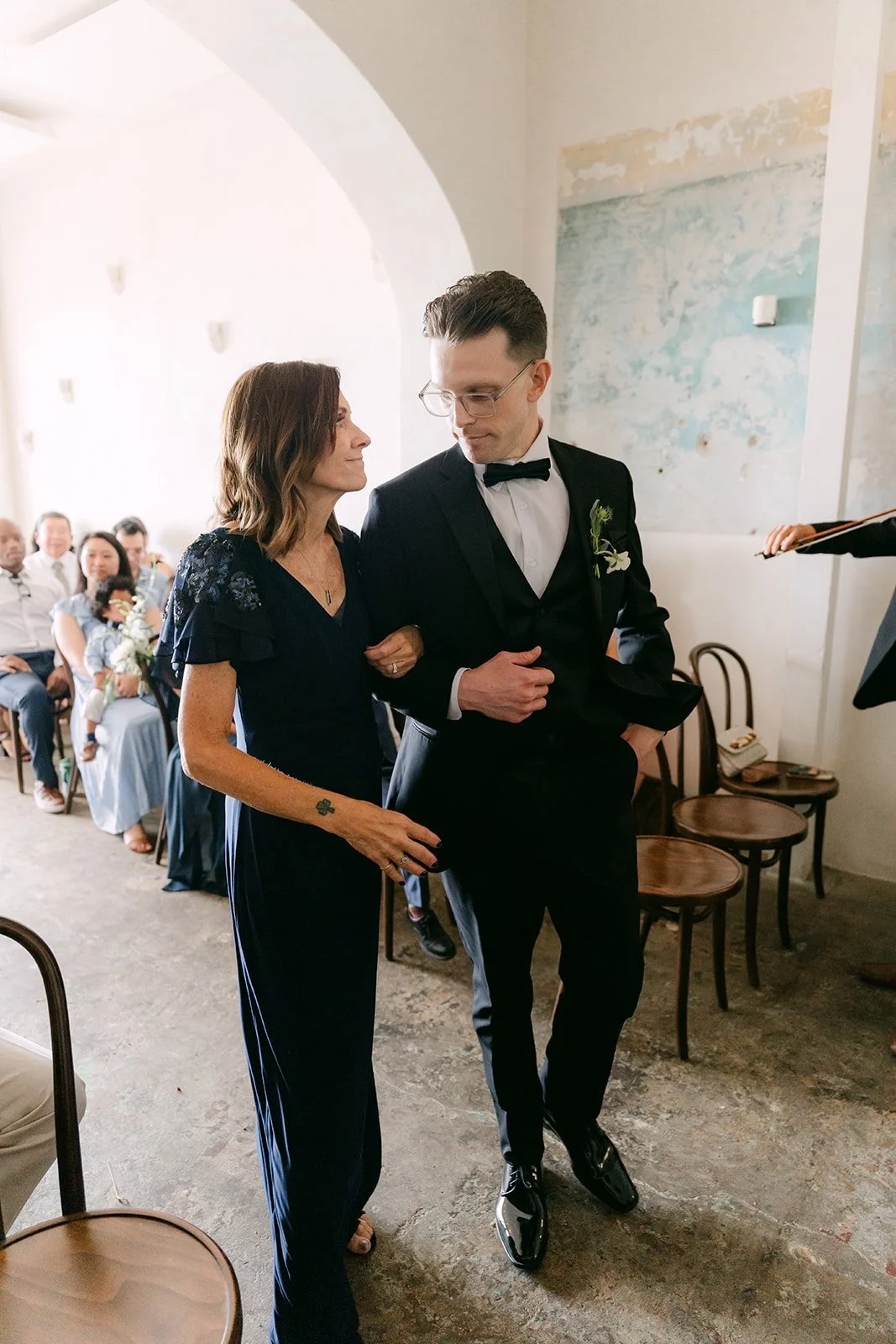Matthew walking his mom down the aisle