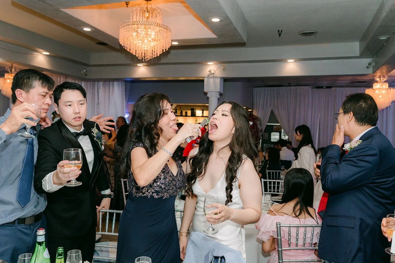 Friends raising their glasses during table greetings