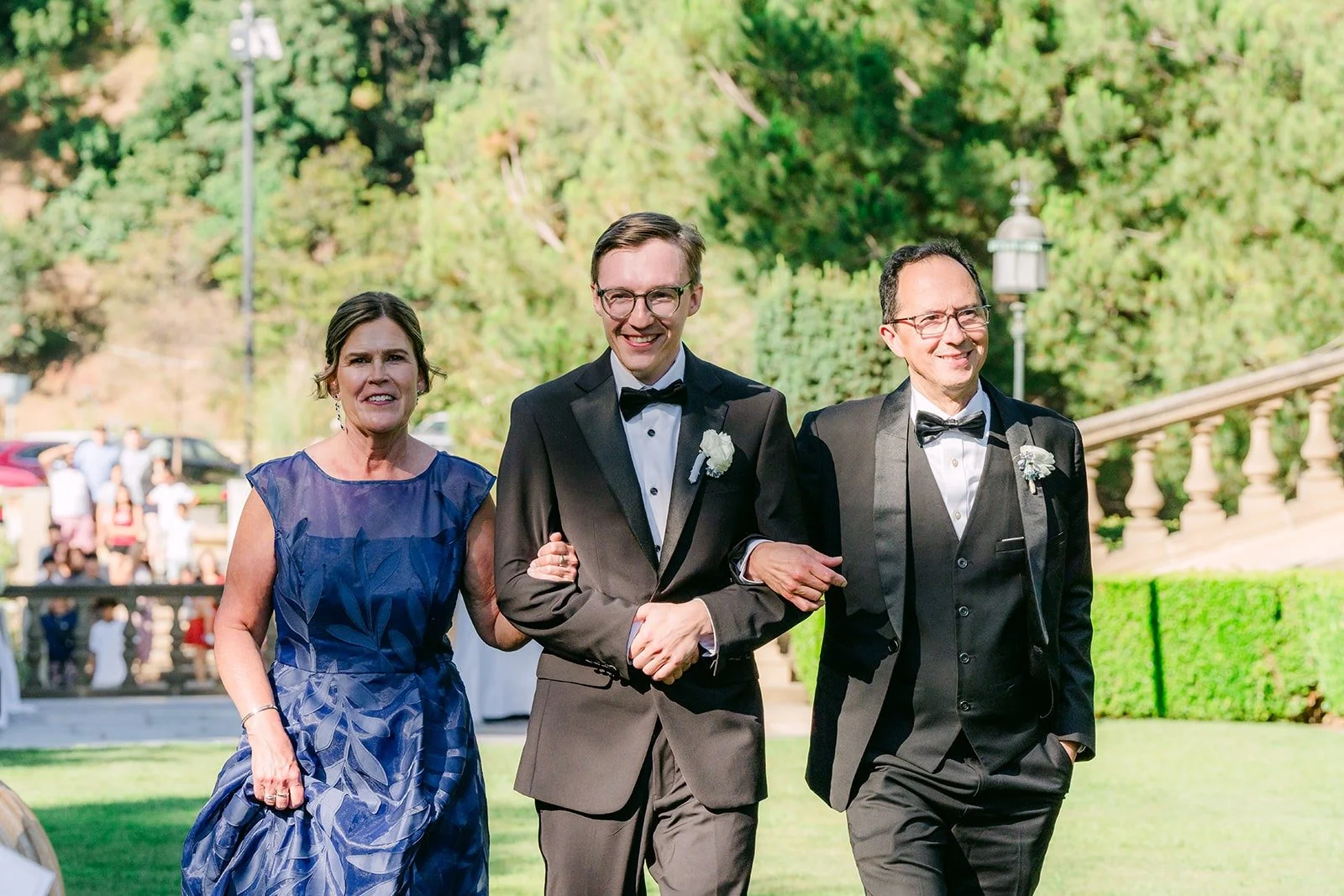 Nik walking down the aisle with family