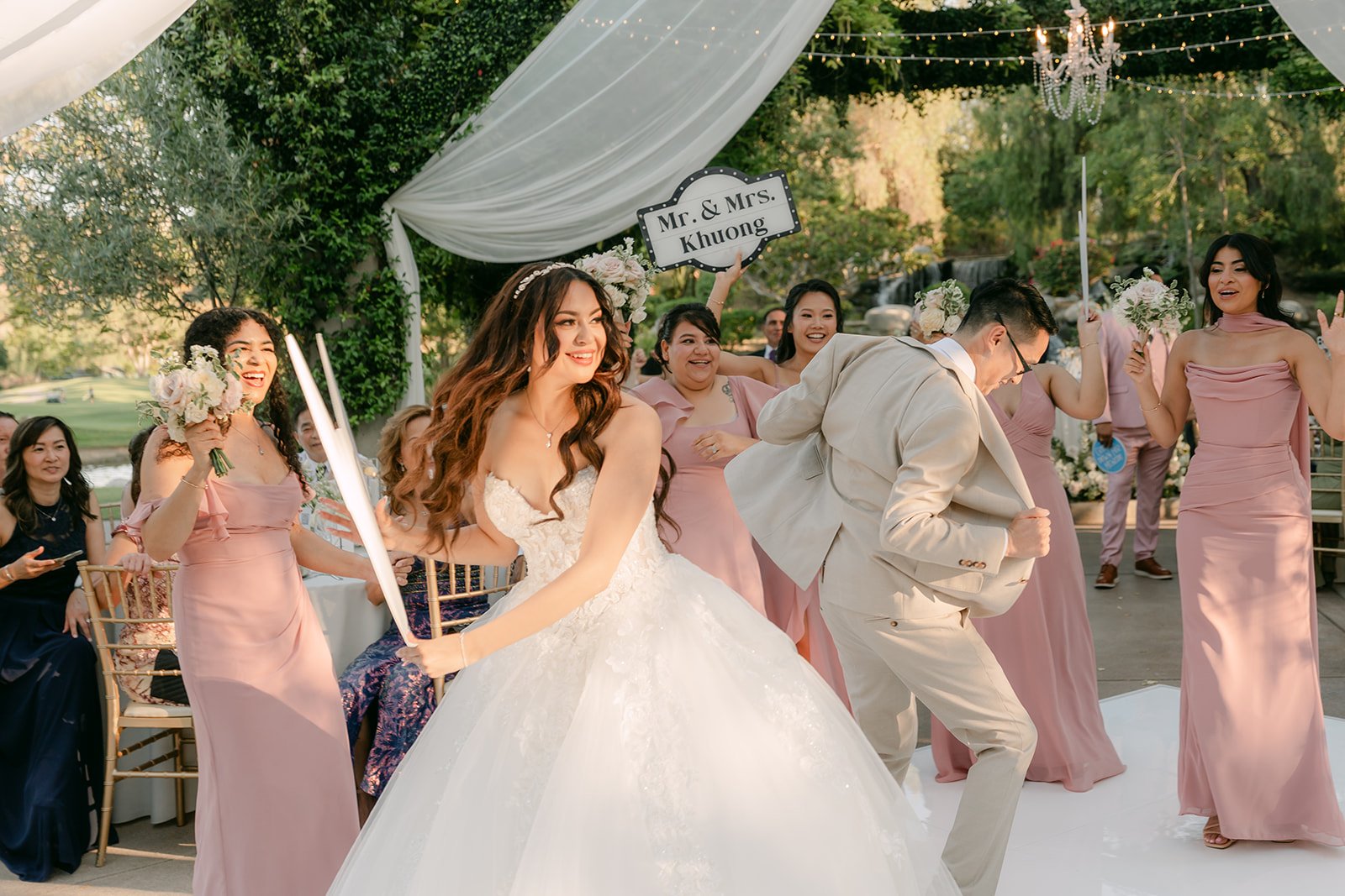 Sandra and Kevin dancing into their reception with the wedding party.