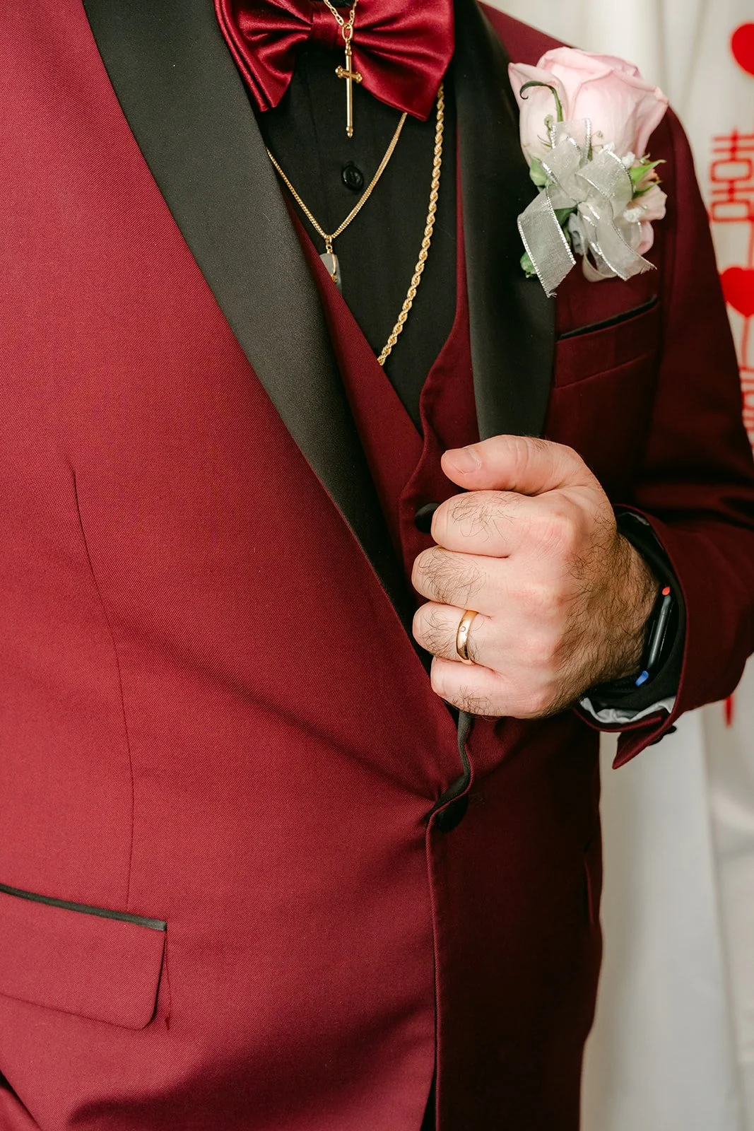 Close-up of Ryan's burgundy suit and boutonniere.
