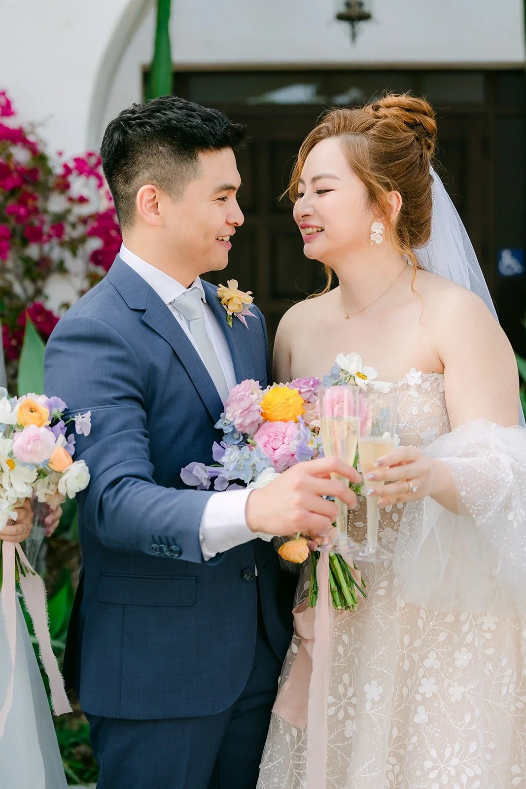 Joanna and Jerrick laughing as they raise their glasses