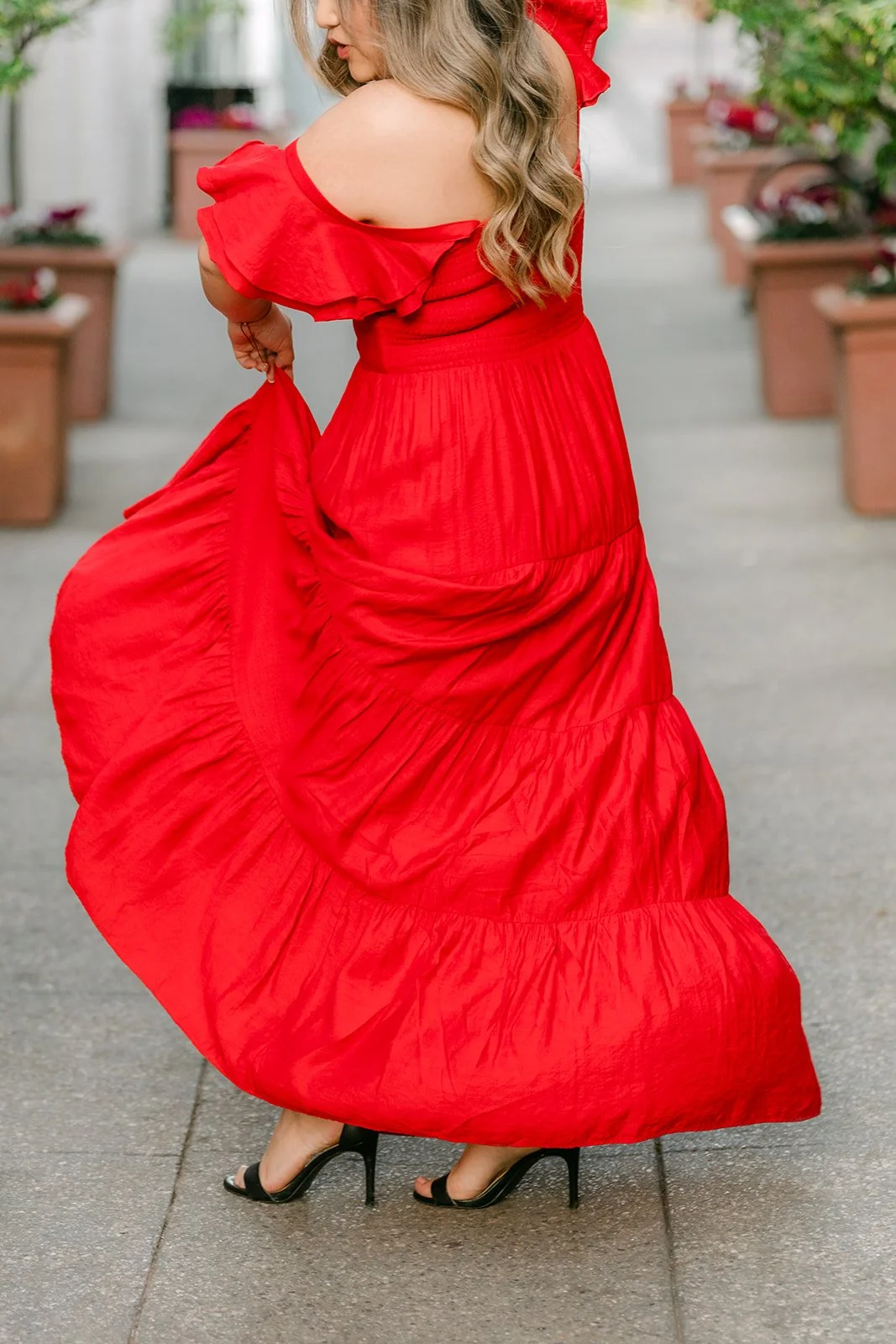 Linh twirls in her red dress in the paseo.