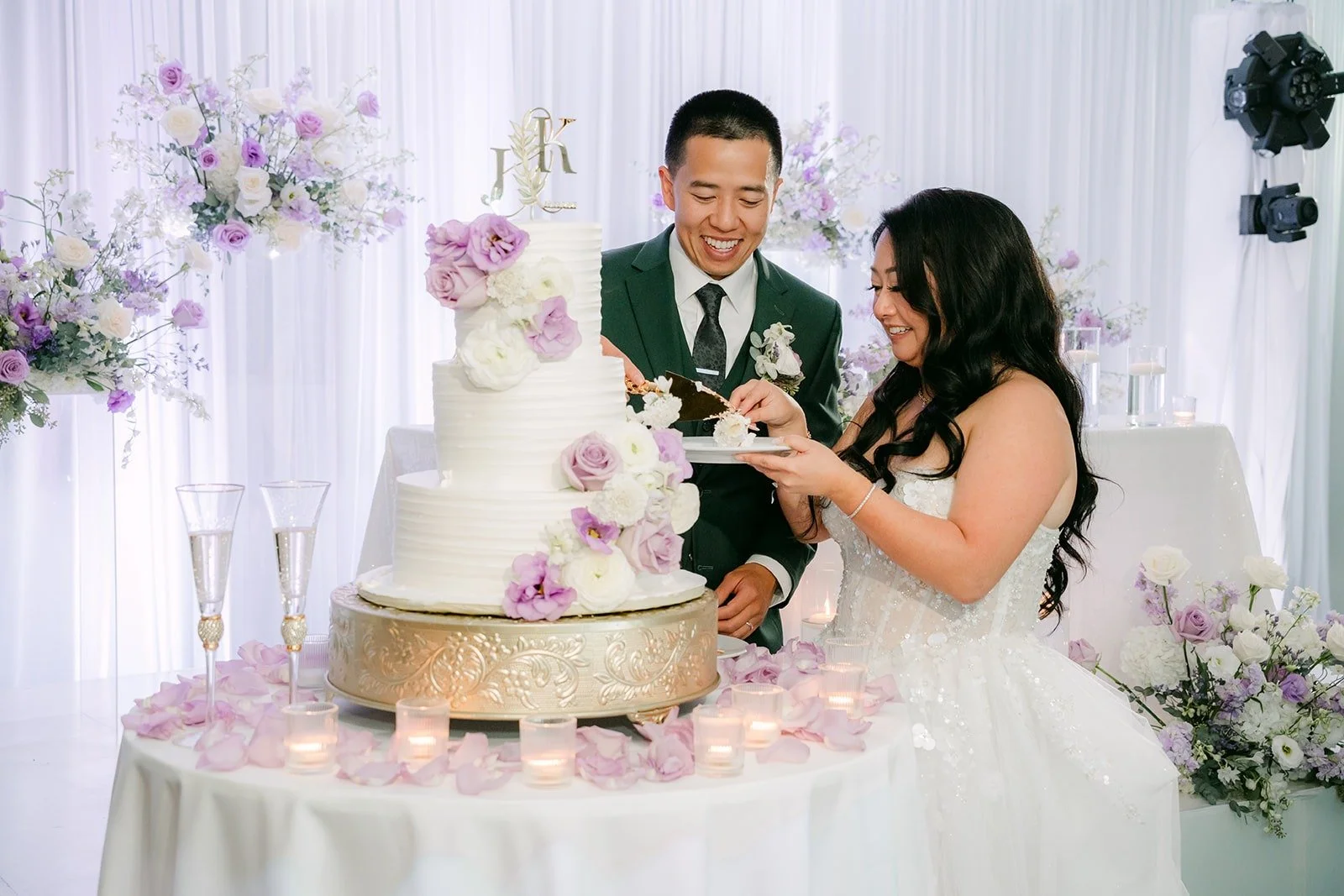 Jennifer feeds Kevin a bite of cake, photographed by One and Only Production