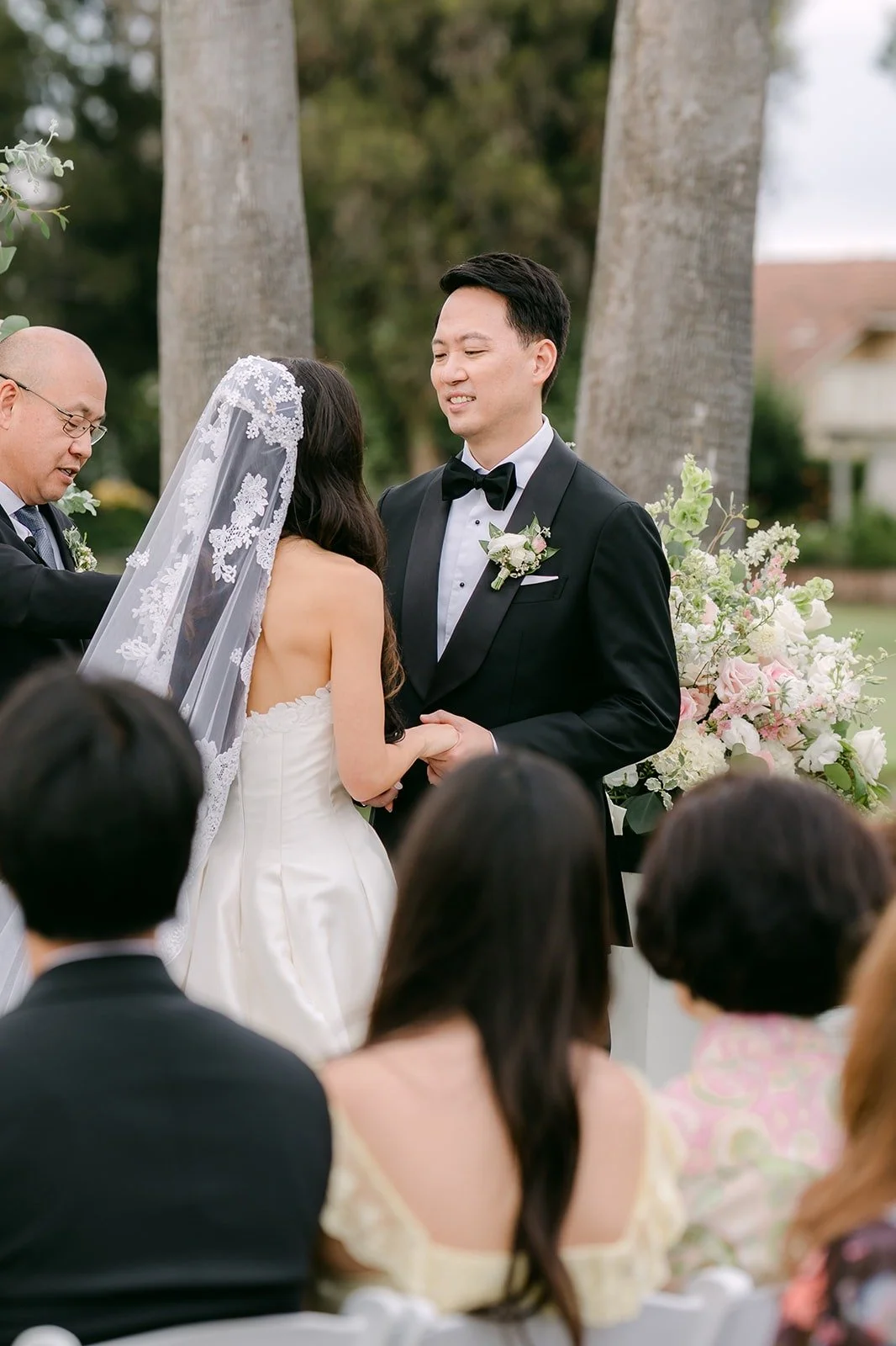 William lifting Kristine's veil during the ceremony
