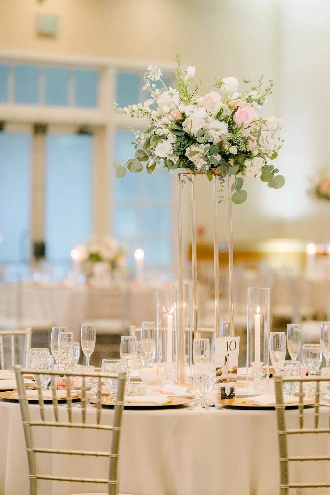 Tall floral centerpieces rising above the reception tables