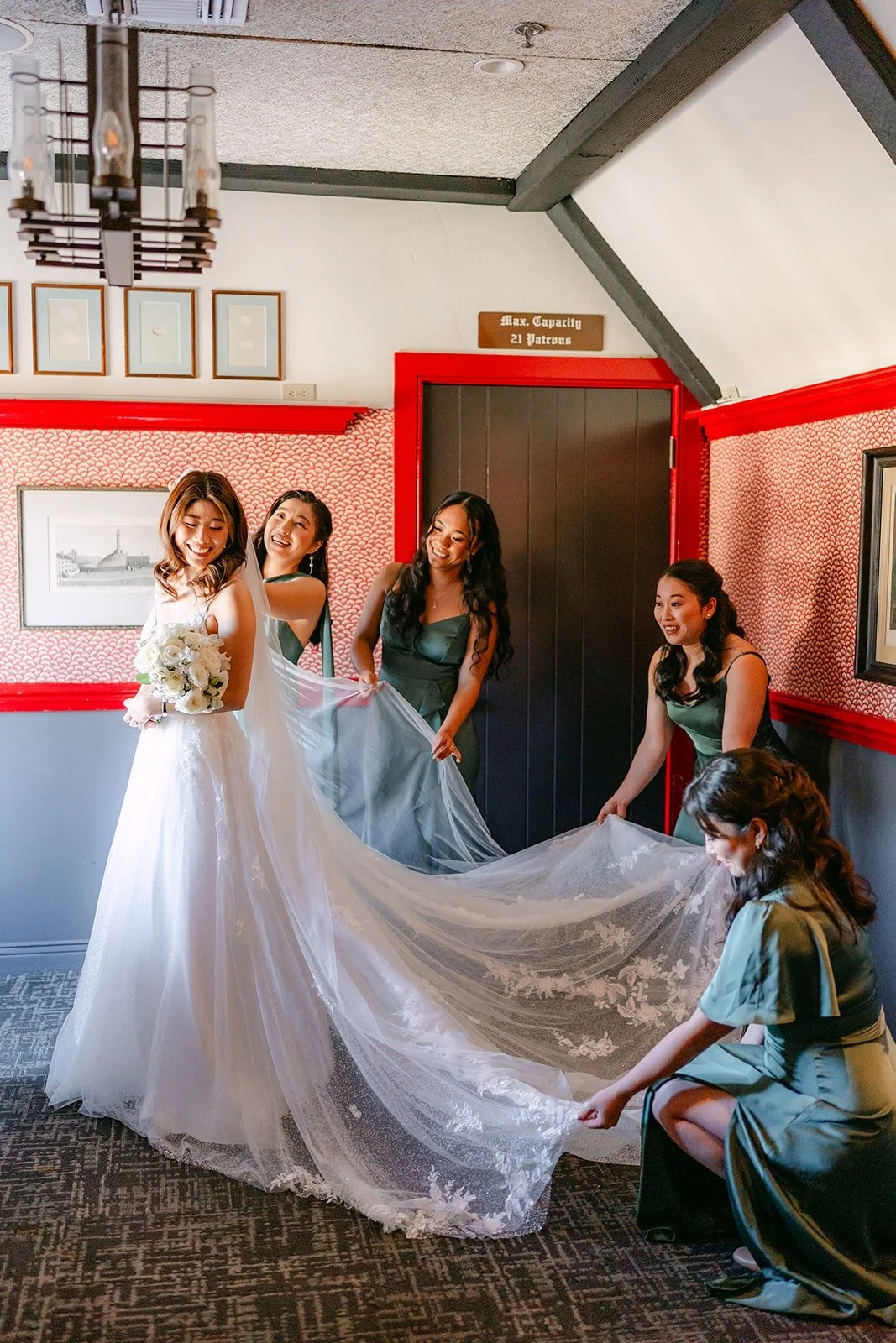 Bridesmaids fluffing Valerie's train before the first look, photographed by One and Only Production