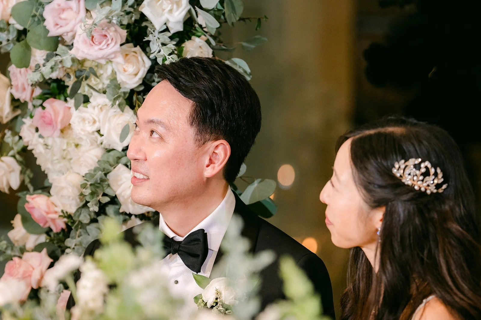 Kristine and William listening at the sweetheart table