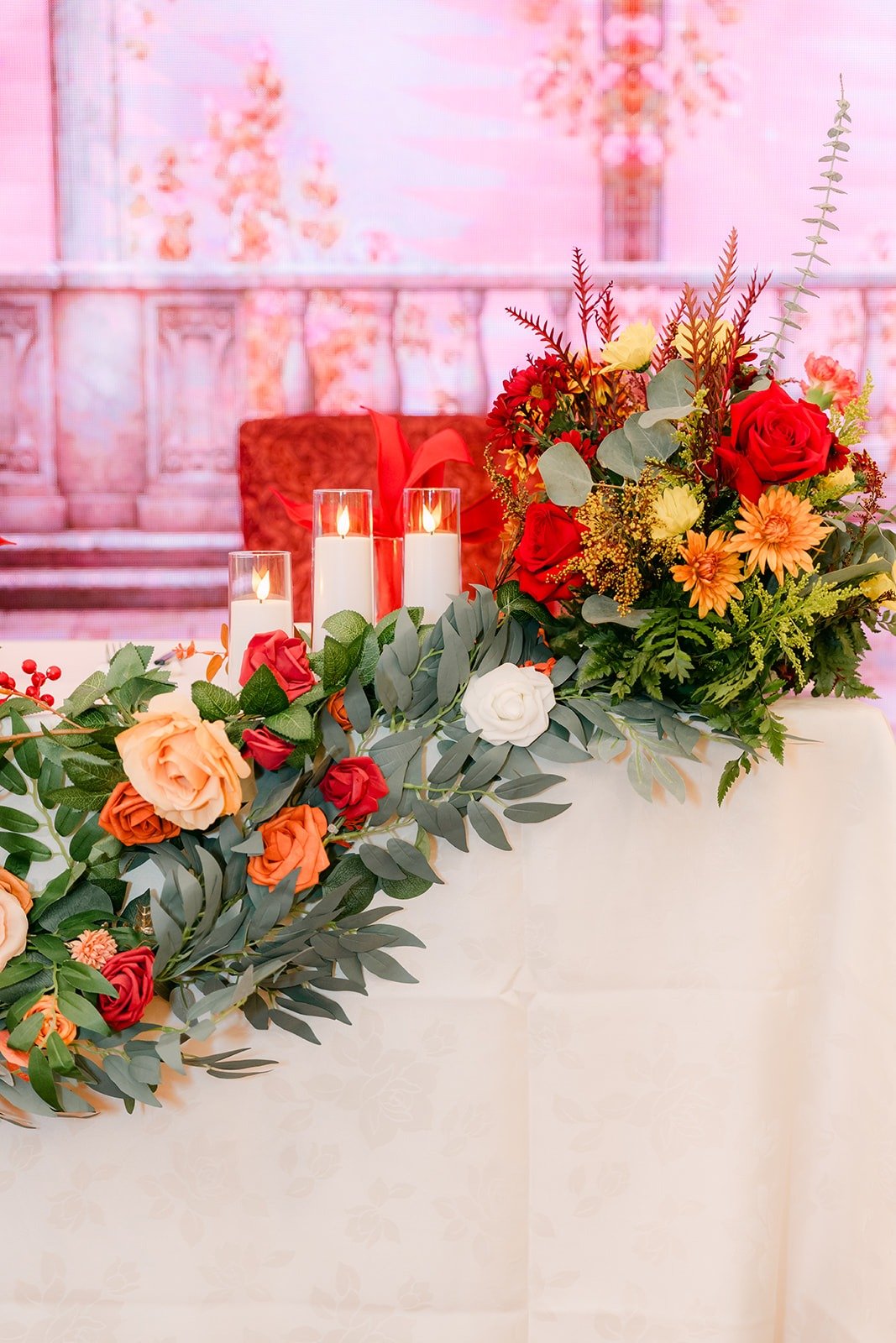 Peach, red and orange florals on the sweetheart table