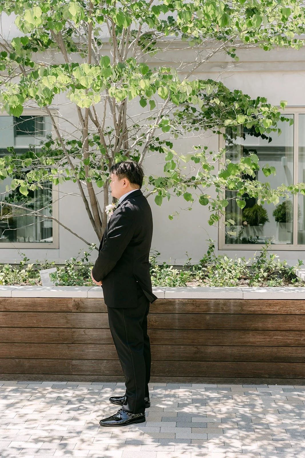 James waiting alone in the courtyard at the Sheraton Los Angeles San Gabriel before the first look