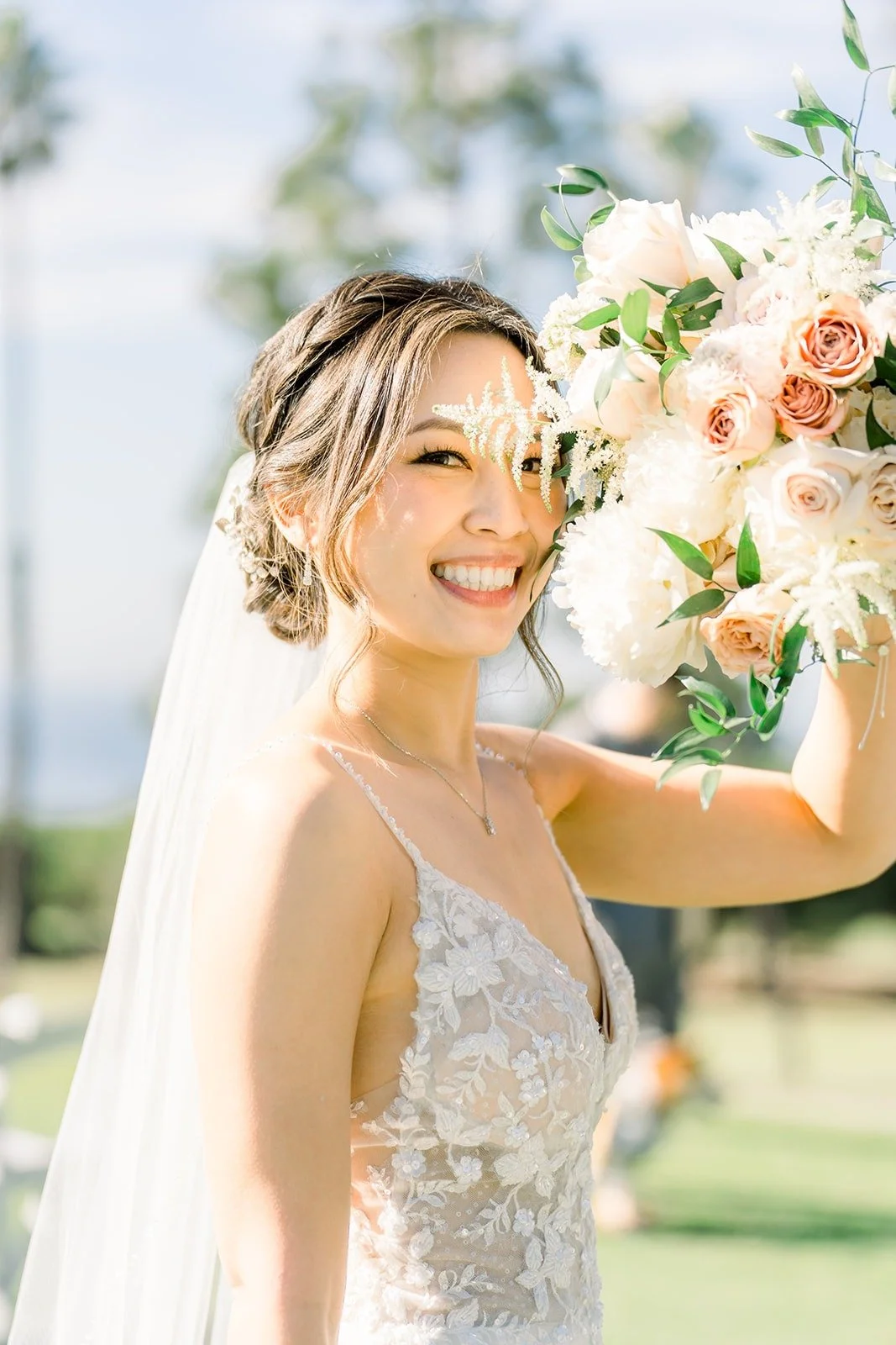Josephine smiling with her bouquet of blush and white roses