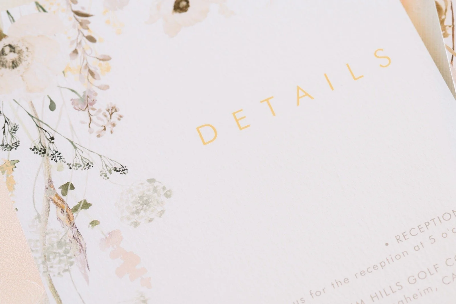 Wedding details card with a soft botanical print