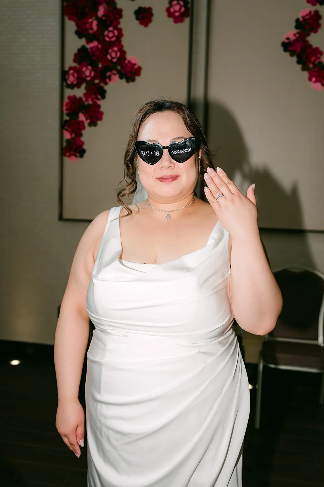 Mai in her sunglasses waving.