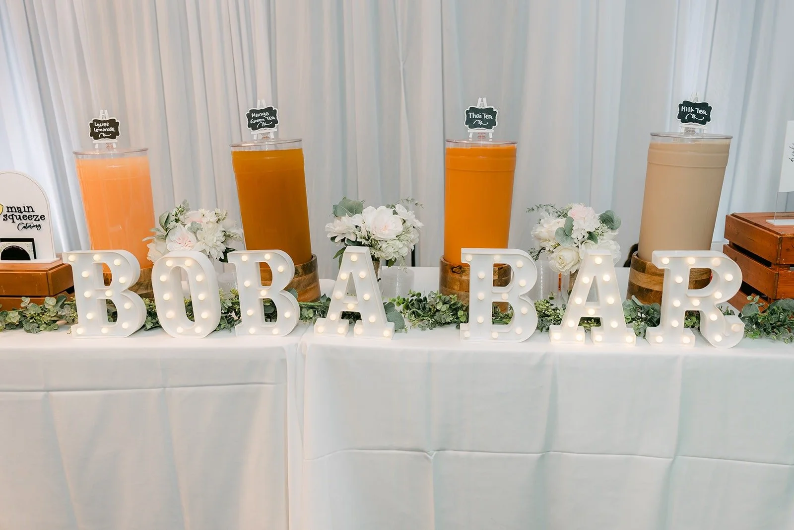 The boba bar from Main Squeeze with white marquee letters