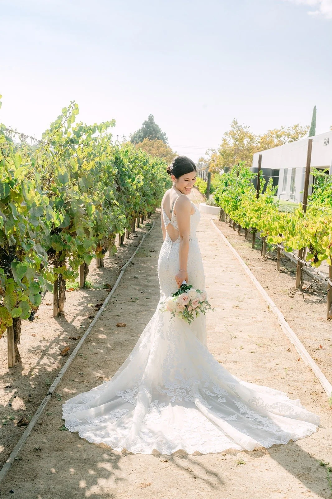 Xuemin looking back over her shoulder in the vineyard
