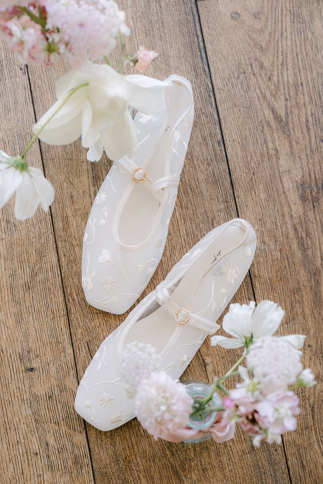 Ivory bridal shoes with pastel blooms