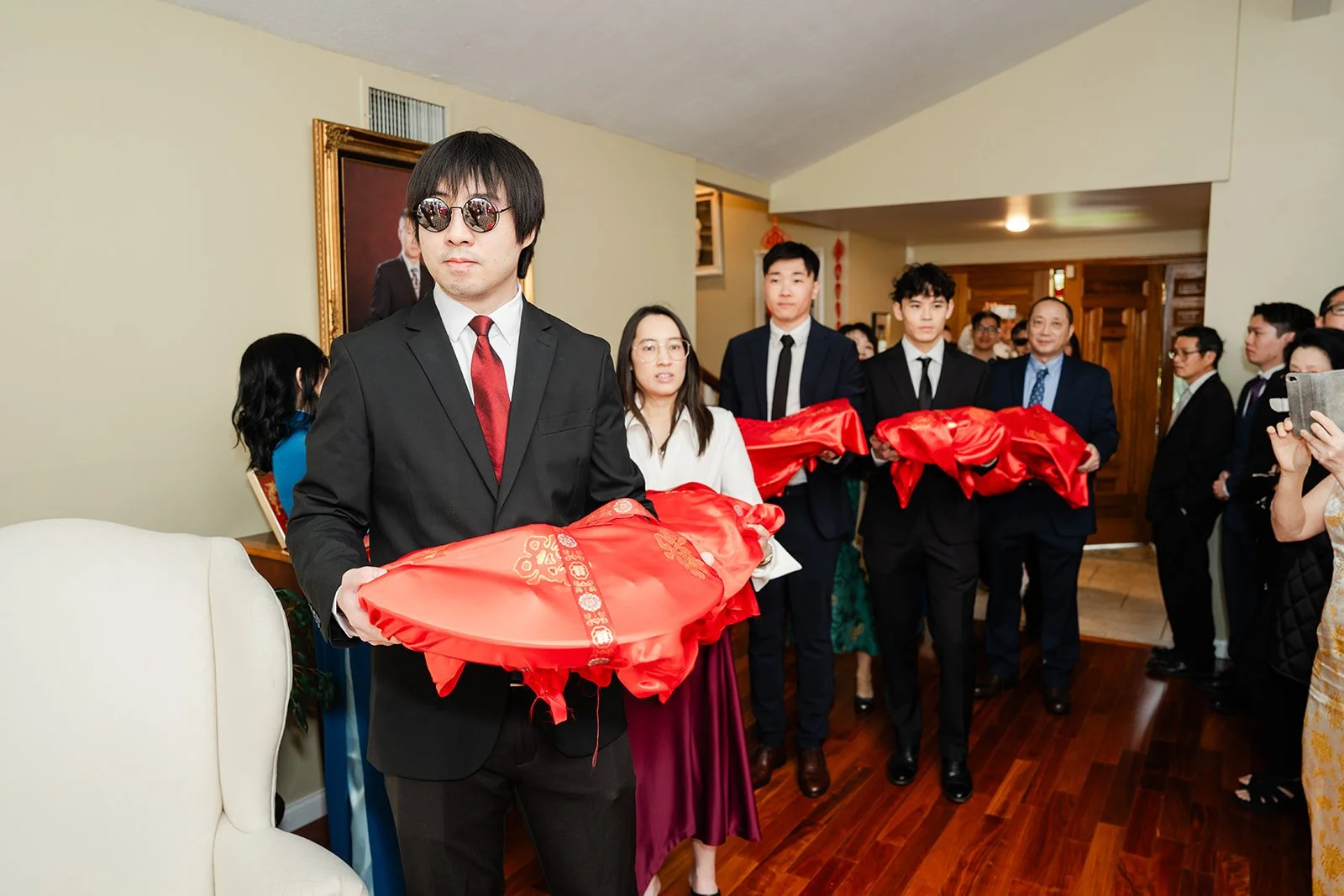 The groom's family lined up with gift trays inside the entry.