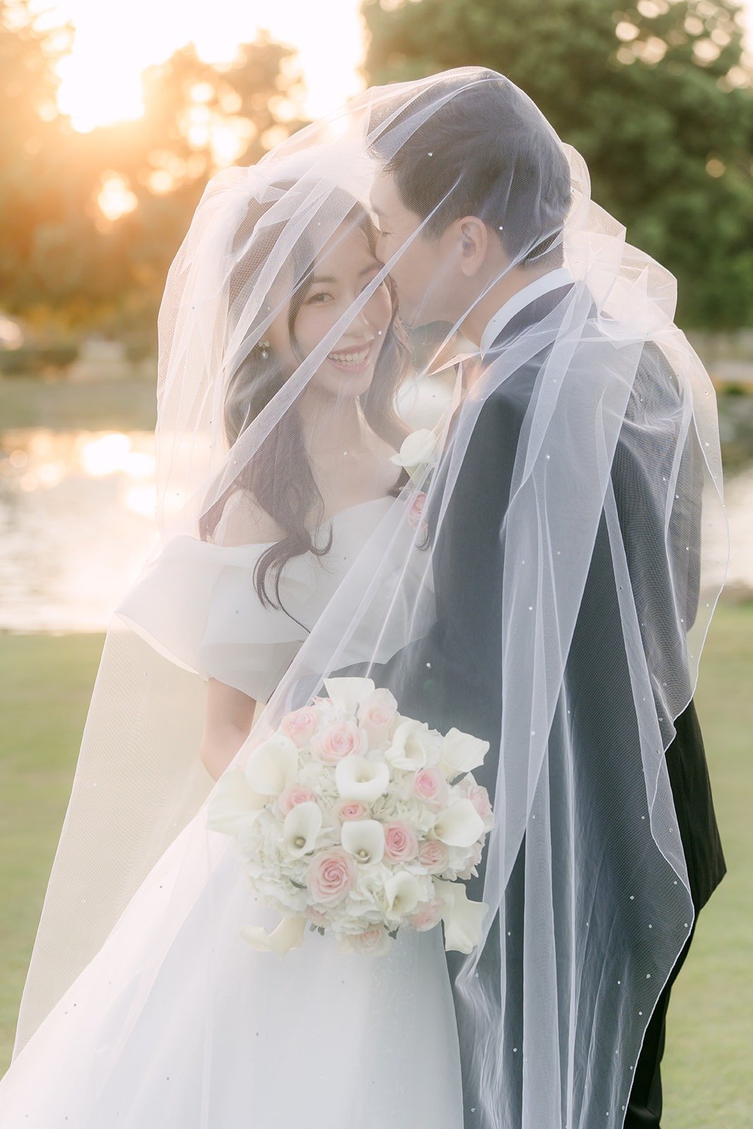 Jeannie and Eunsang wrapped in her veil at golden hour