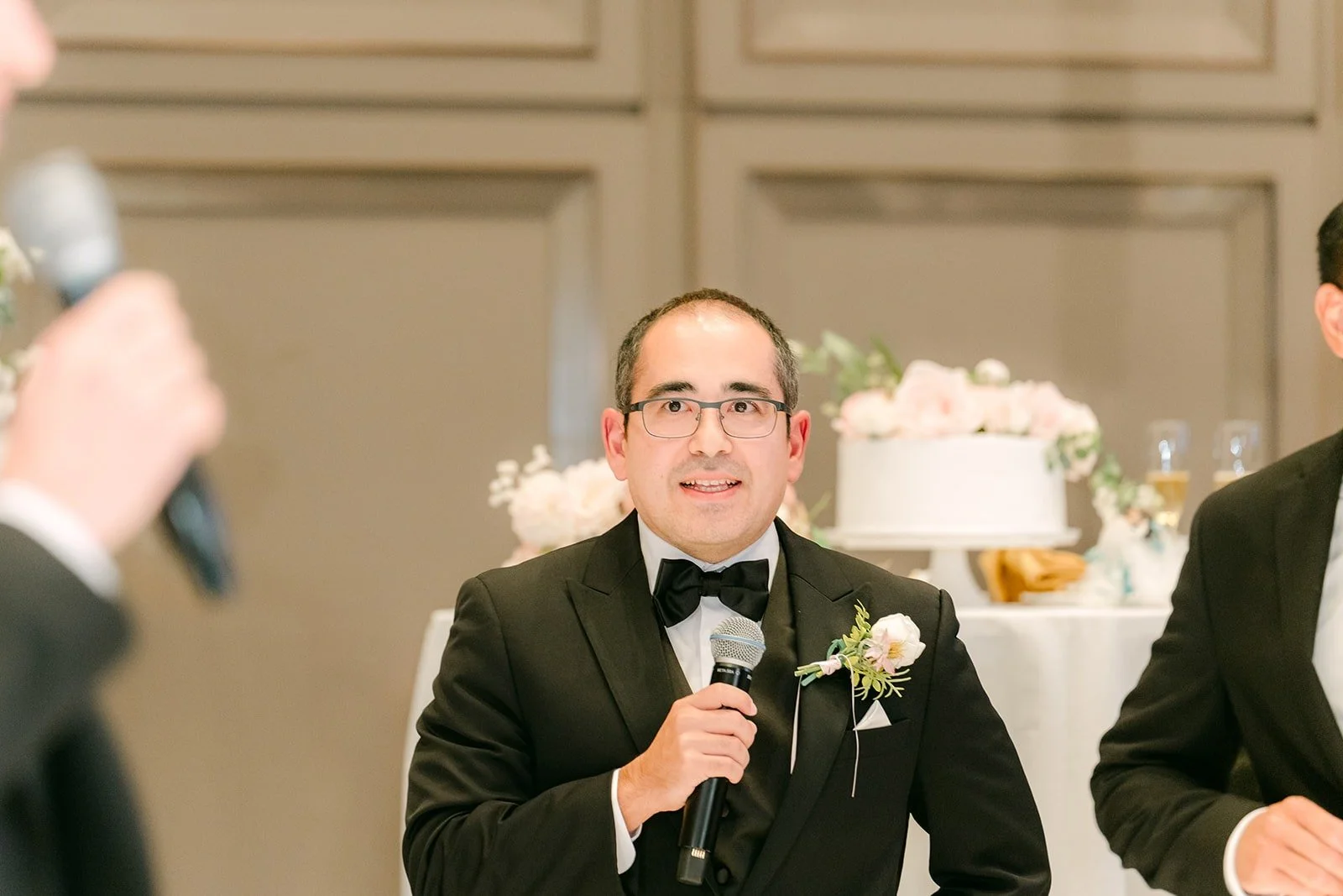 A groomsman holding the microphone during the reception games