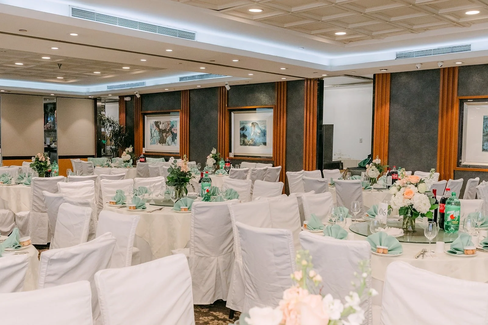The banquet room at Five Star Seafood Restaurant set with white linens and floral centerpieces