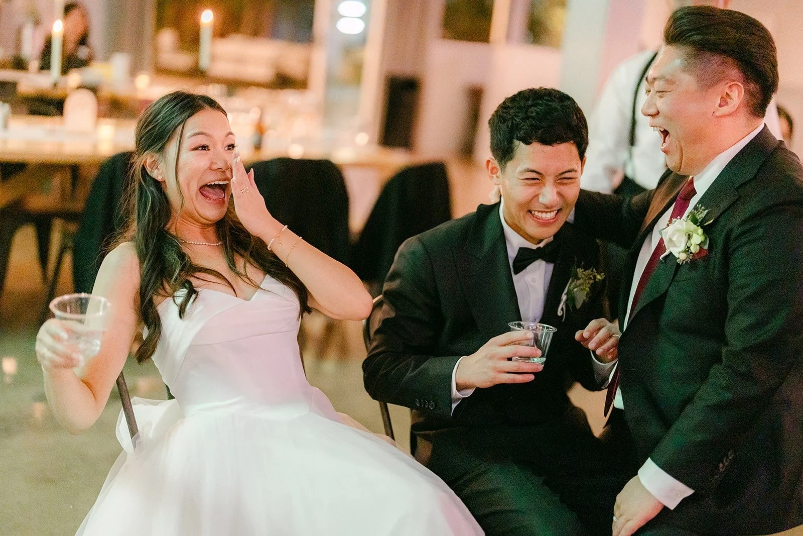 Jadee and Richard laughing with friends on the dance floor