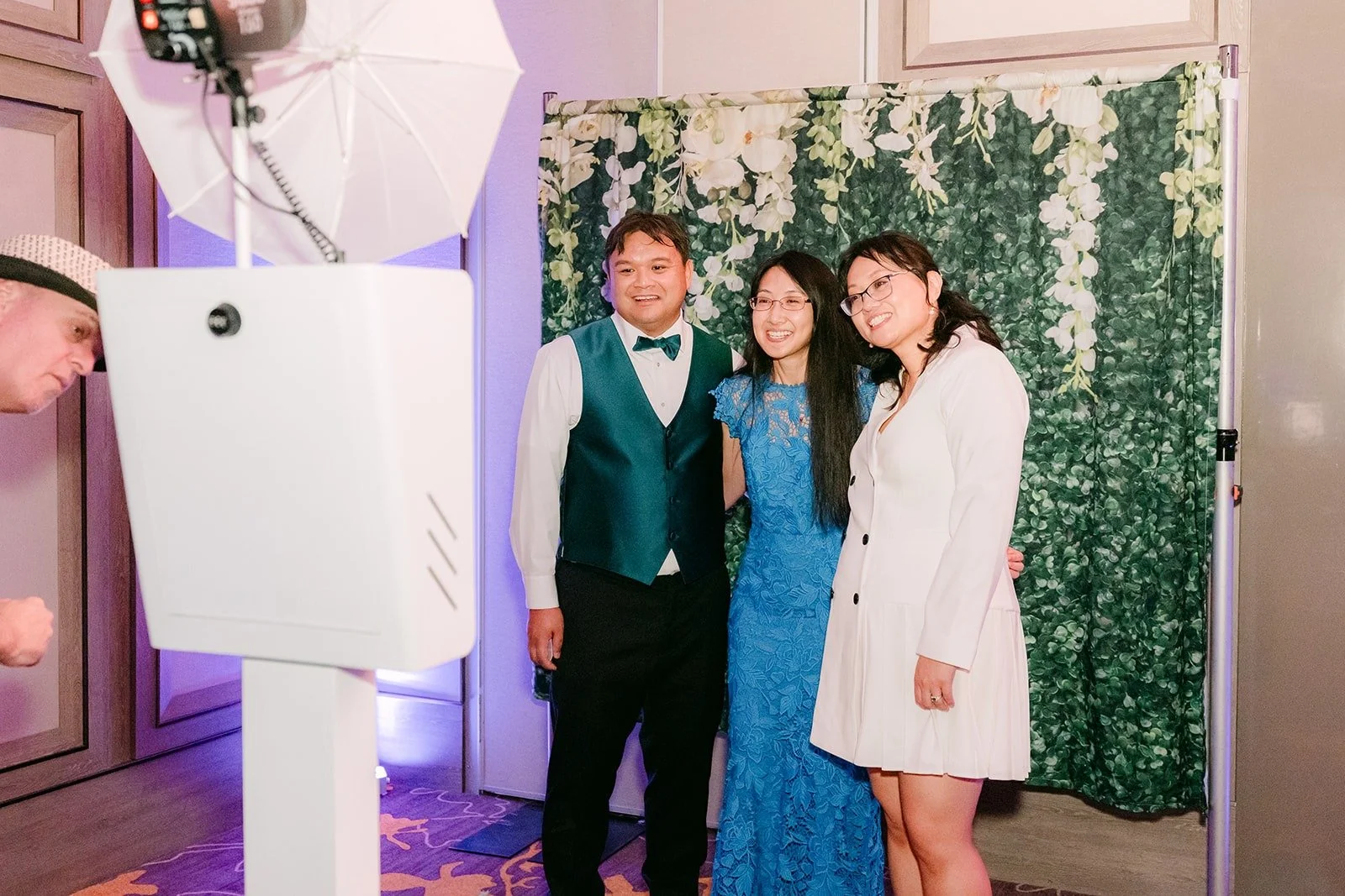James and Stella with a guest at the photo booth, photographed by One and Only Production