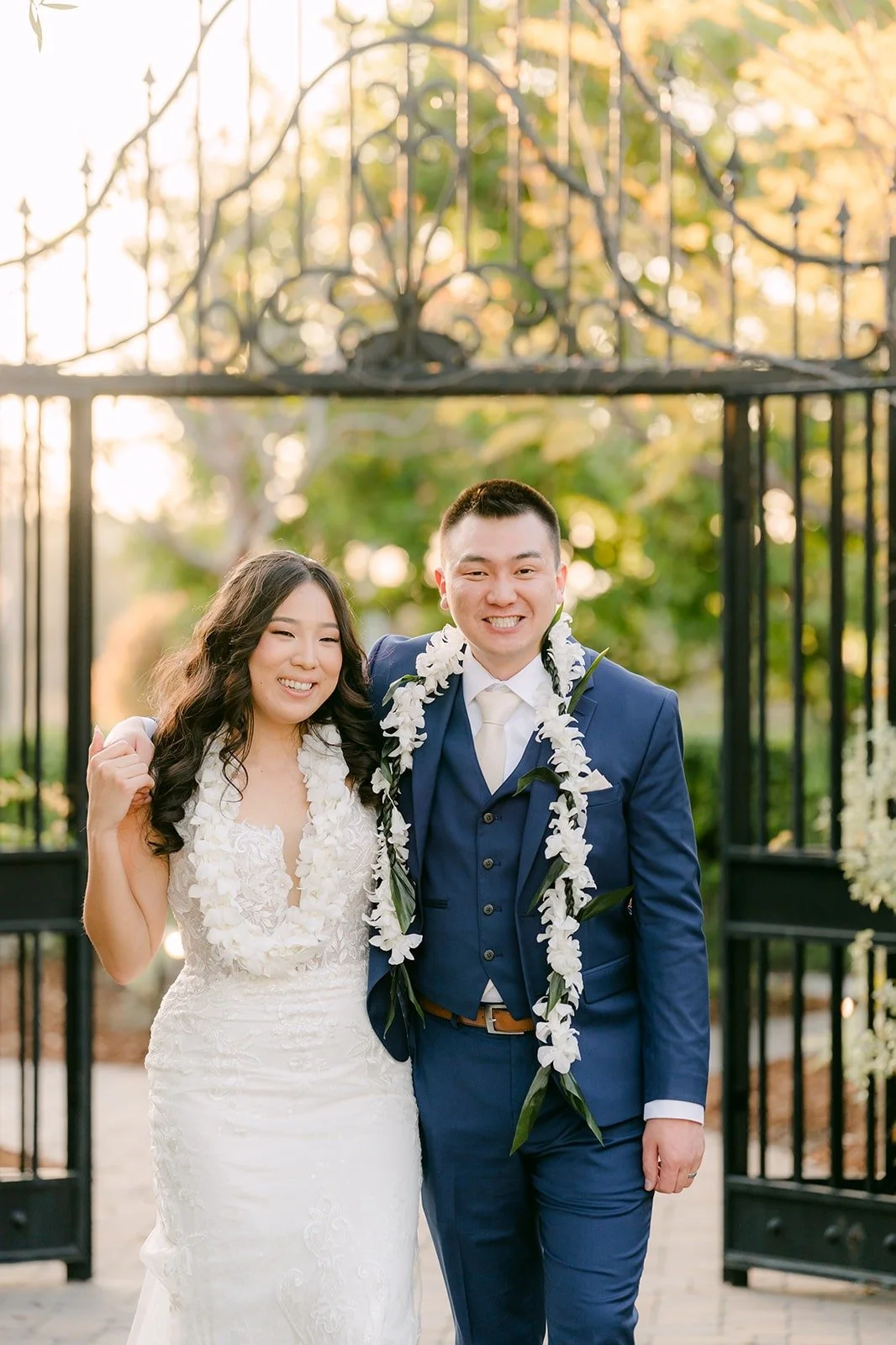 Kelli and Alex in front of the iron gate at Los Robles Greens, photographed by One and Only Production