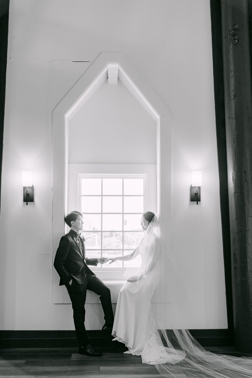 Tin and Fong sitting together by an arched window