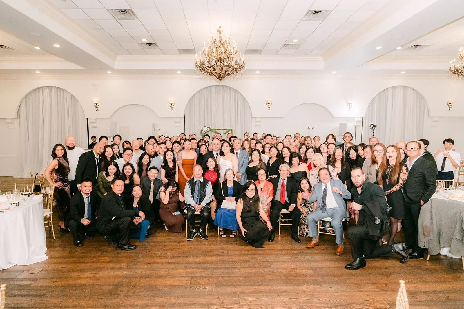 All the guests together for a group photo in the ballroom