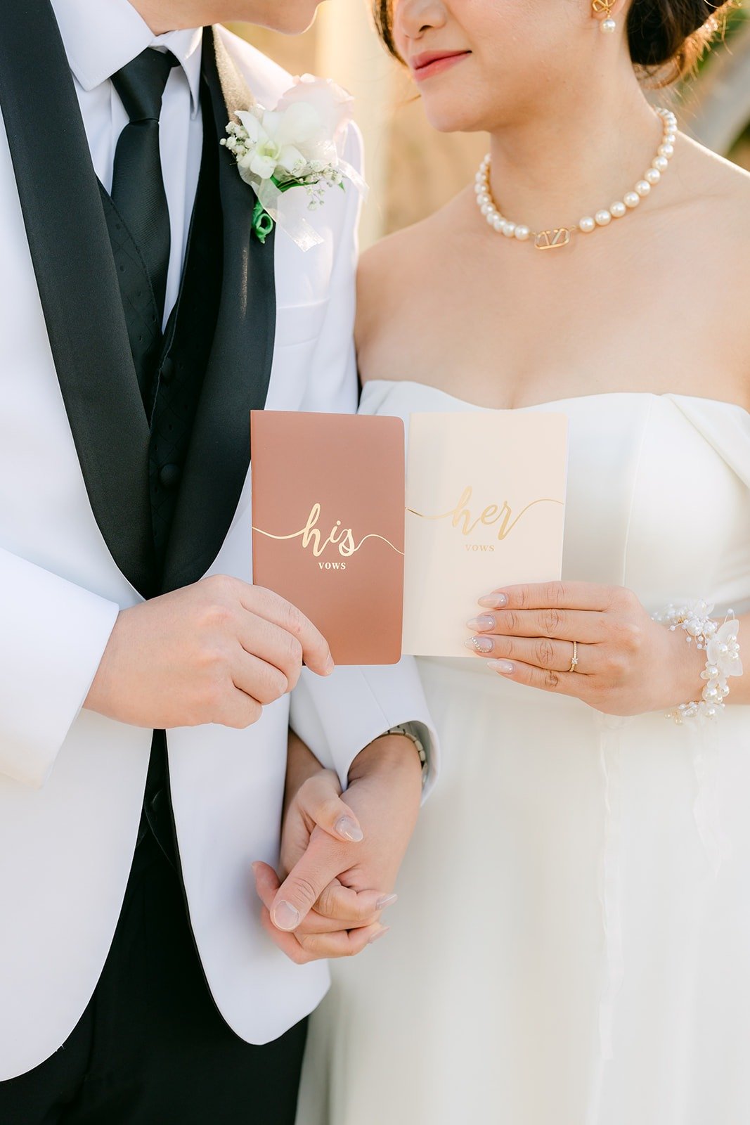 Ivy and Chungman holding hands with their vow books