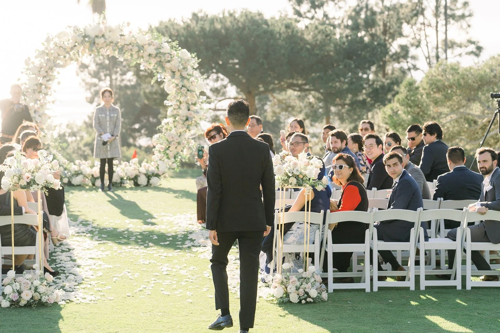 David walking down the aisle toward the floral arch