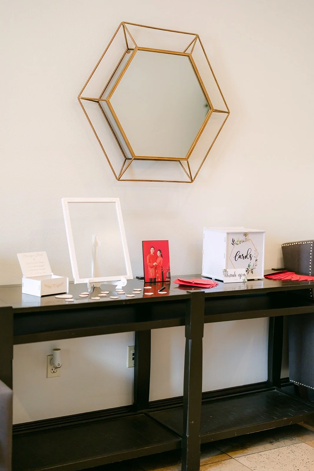 Welcome table with a gold hexagon mirror and guestbook