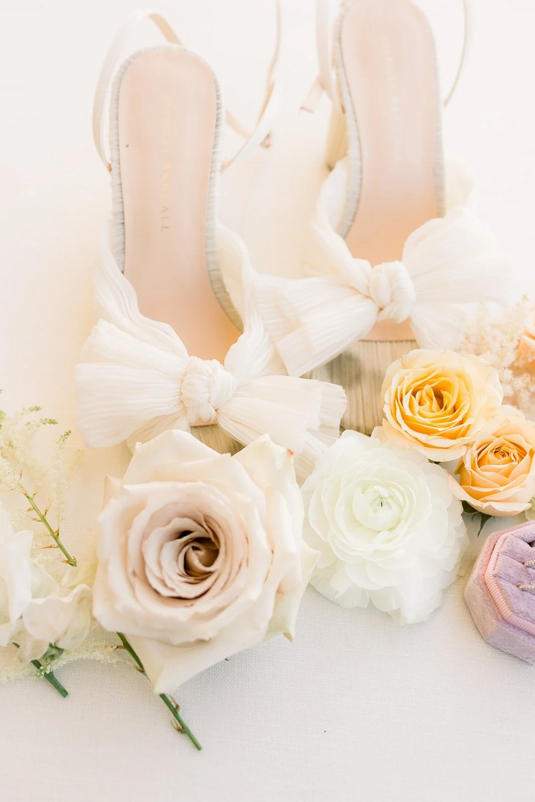 Josephine's ivory bow heels among peach and blush roses