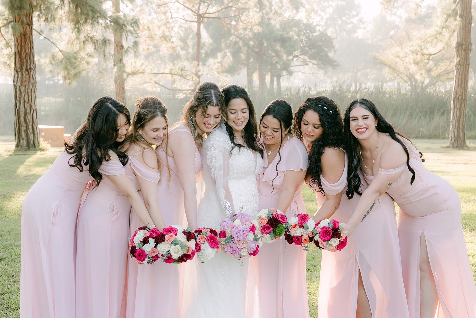 Bridesmaids laughing with Amy, bouquets in hand