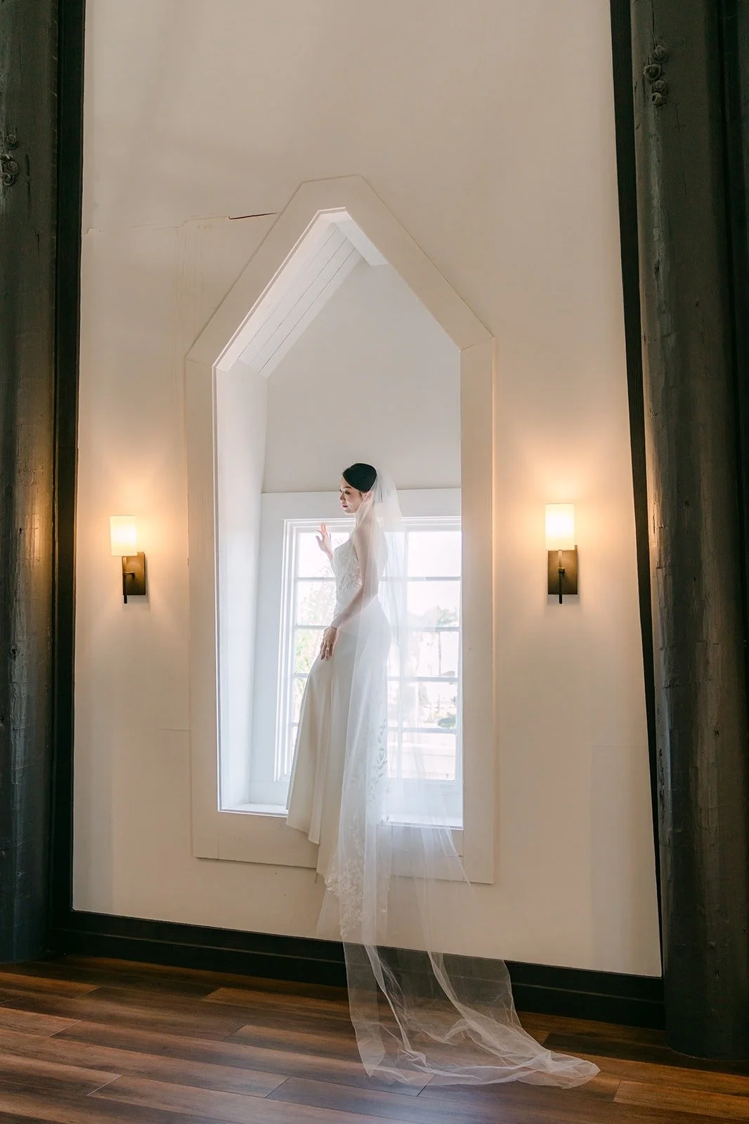 Tin standing in the window light with her long veil