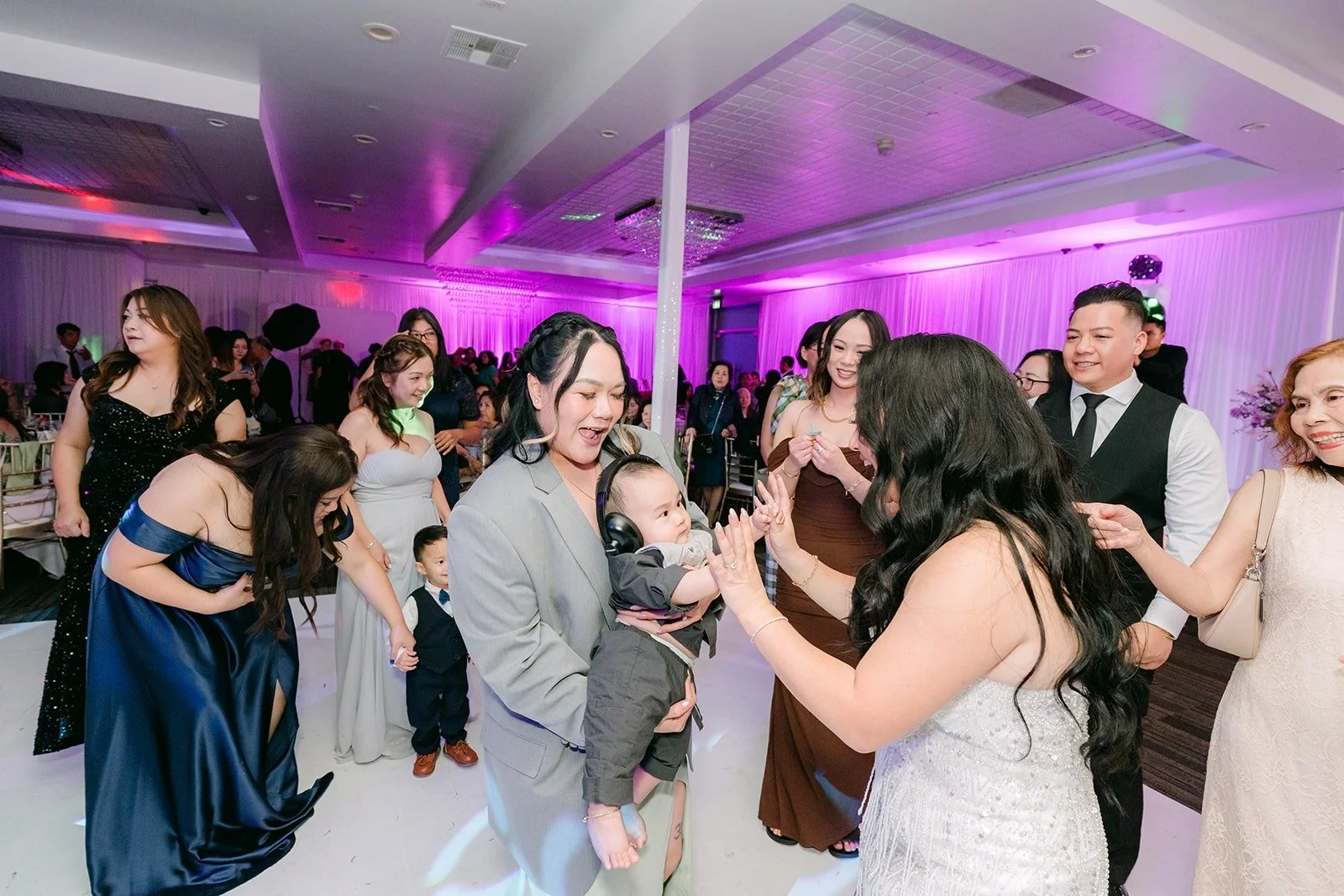 Jennifer dances with friends under purple lights
