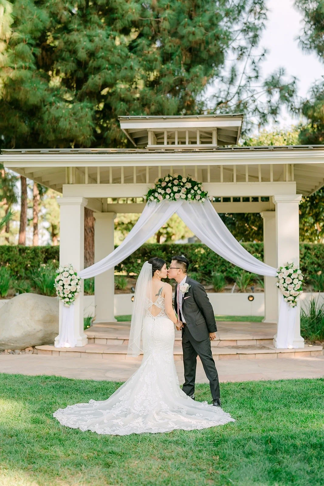 Xuemin and Alex in front of the white gazebo at the Turnip Rose