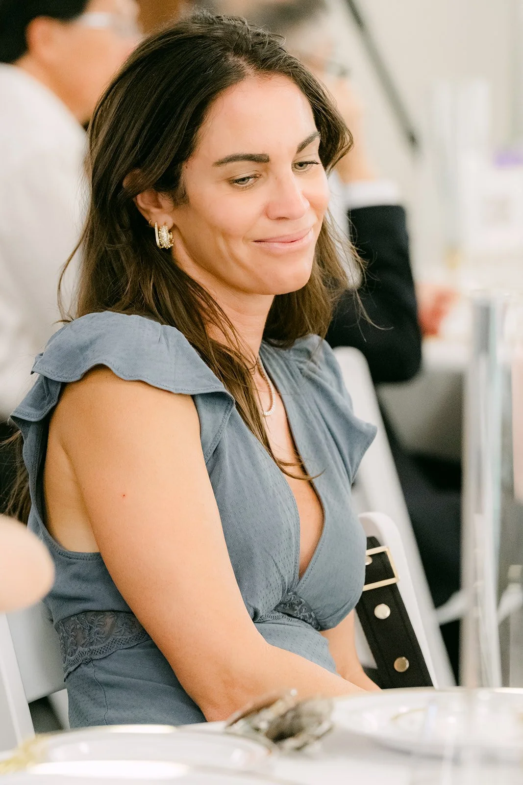 A guest smiling during the speeches.
