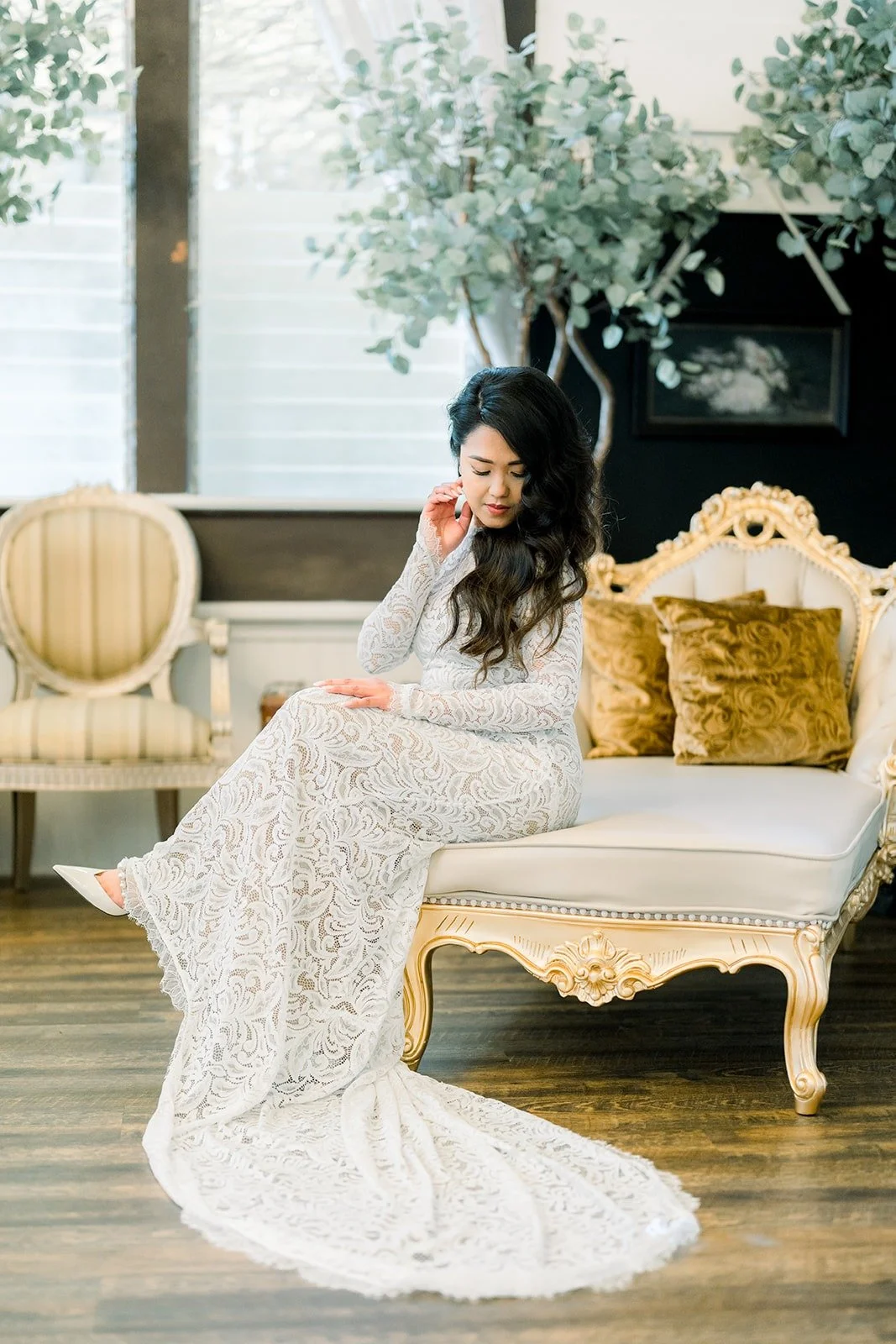 Hannah seated on a vintage chaise in the bridal suite