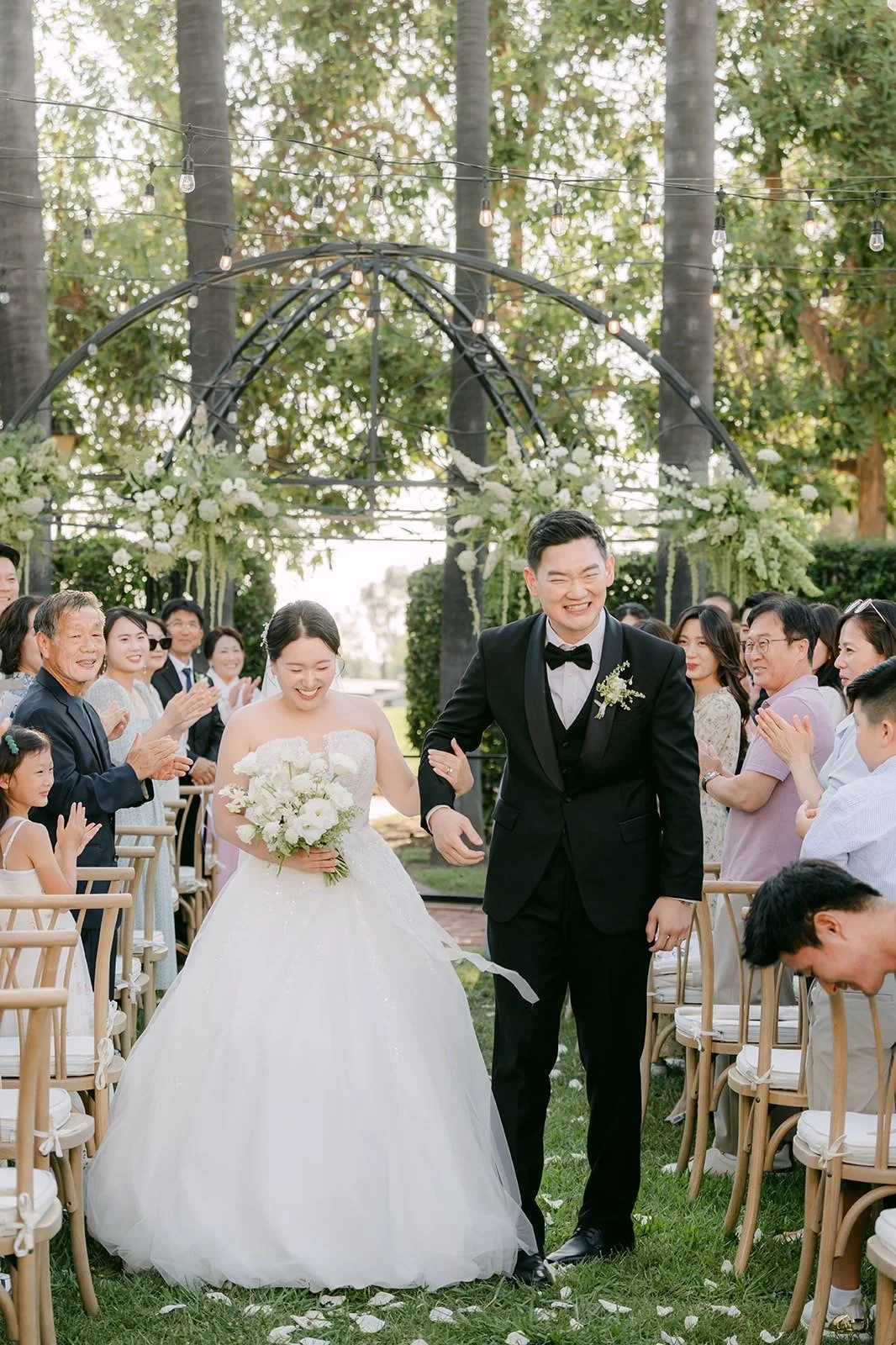 Amy and Sam walking back up the aisle as husband and wife