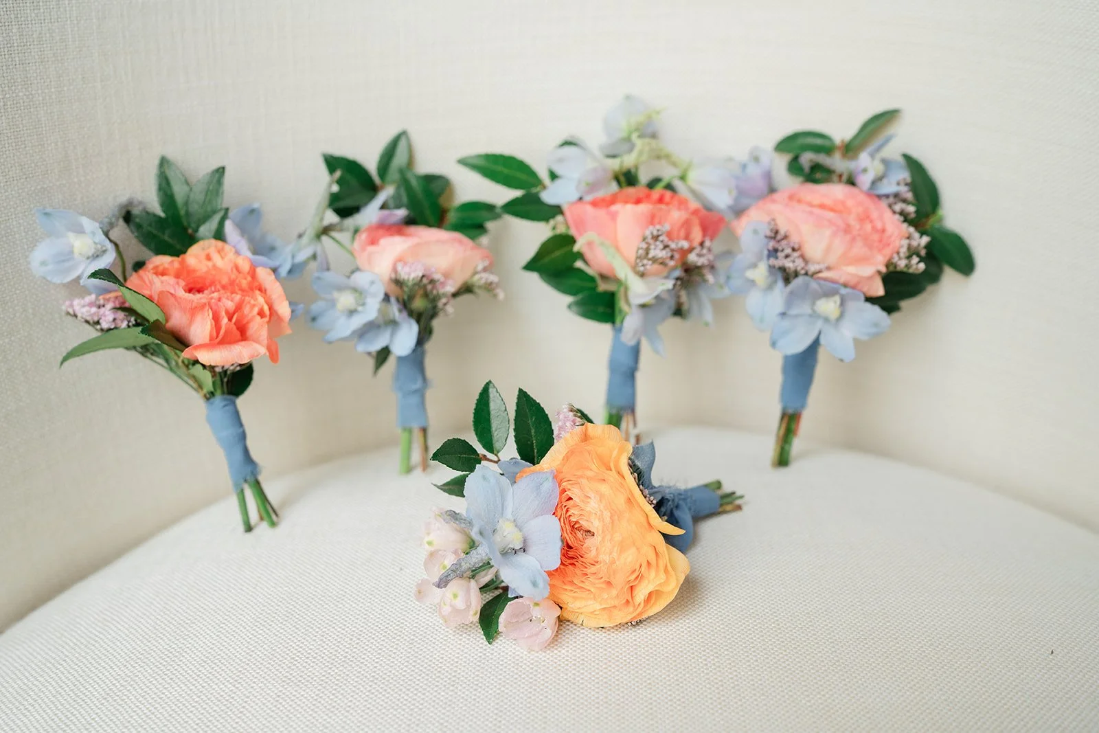 Peach and blue boutonnieres from A Touch of Lavender