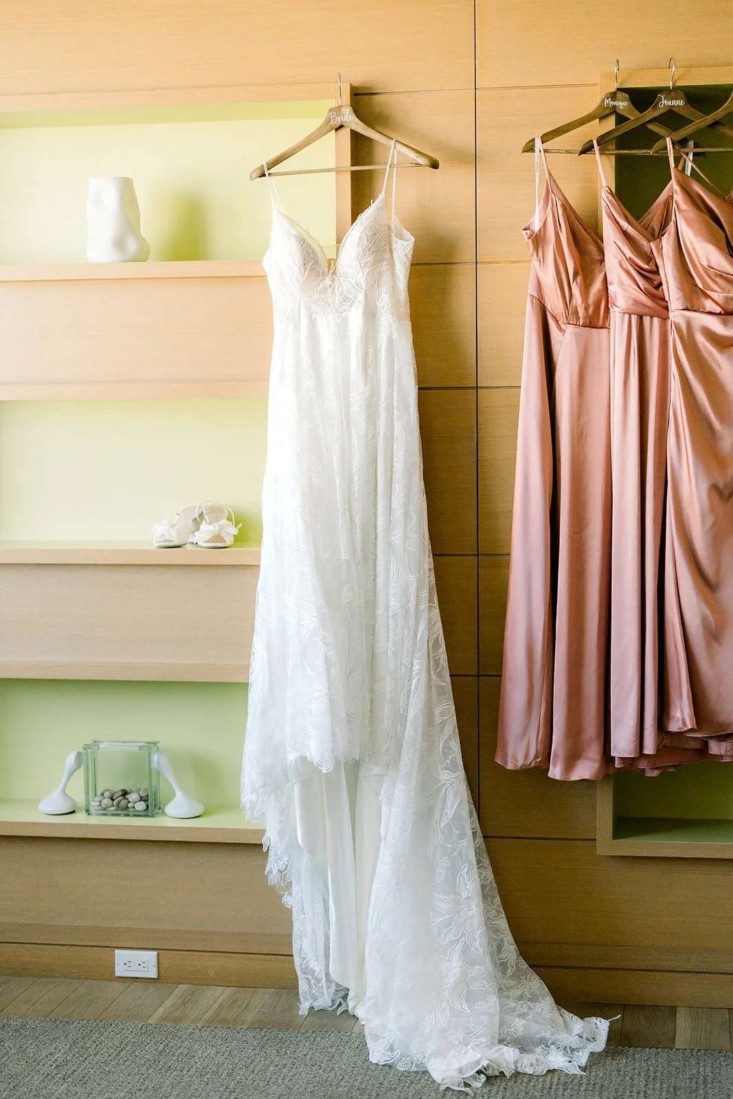 Betsy's lace gown hanging beside the dusty rose bridesmaid dresses