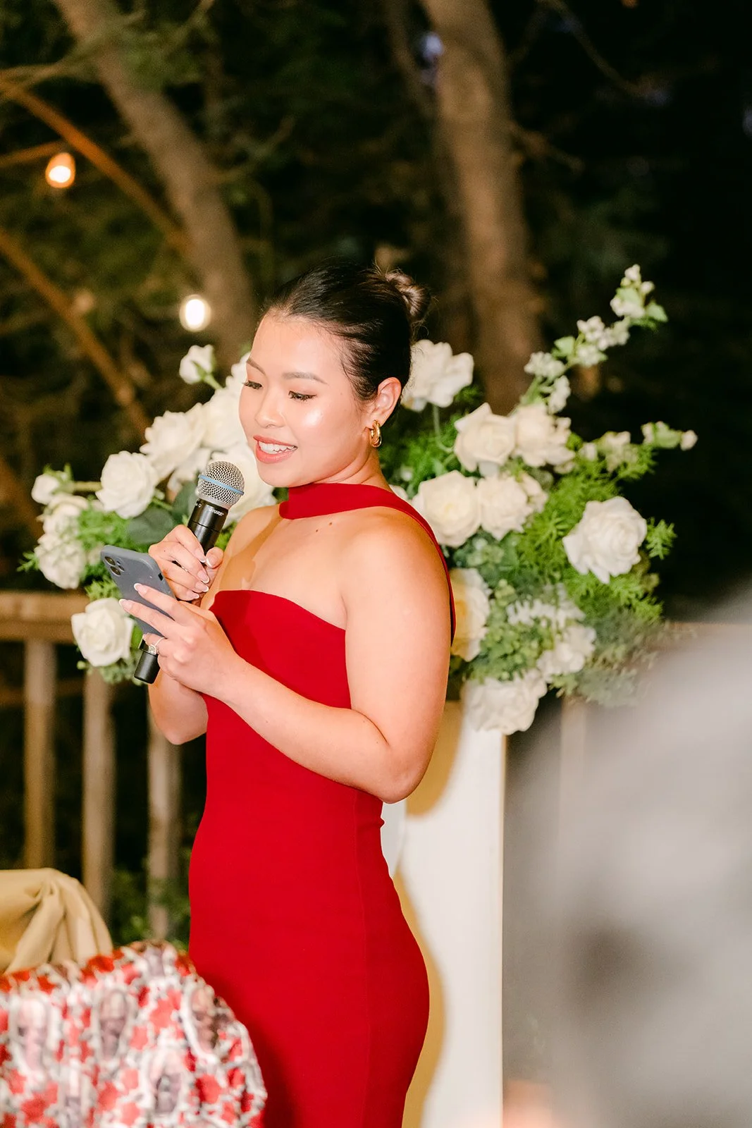 Maid of honor in red sharing a toast to the couple