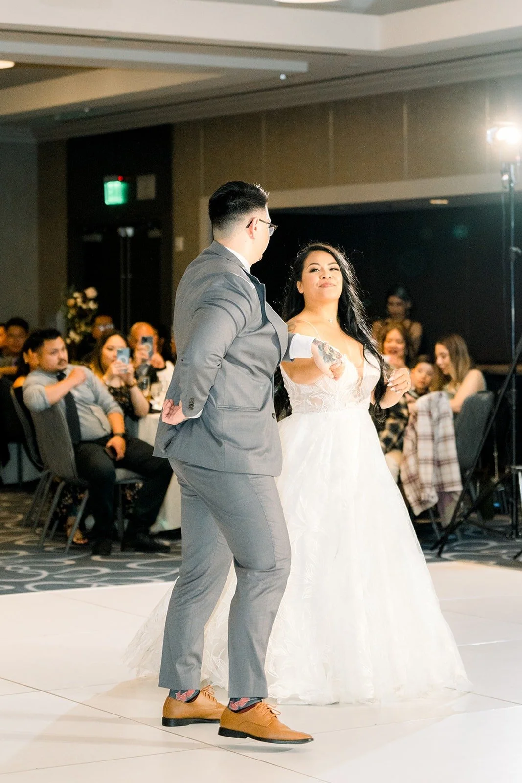 Betsy and Mikey dance as guests look on, photographed by One and Only Production