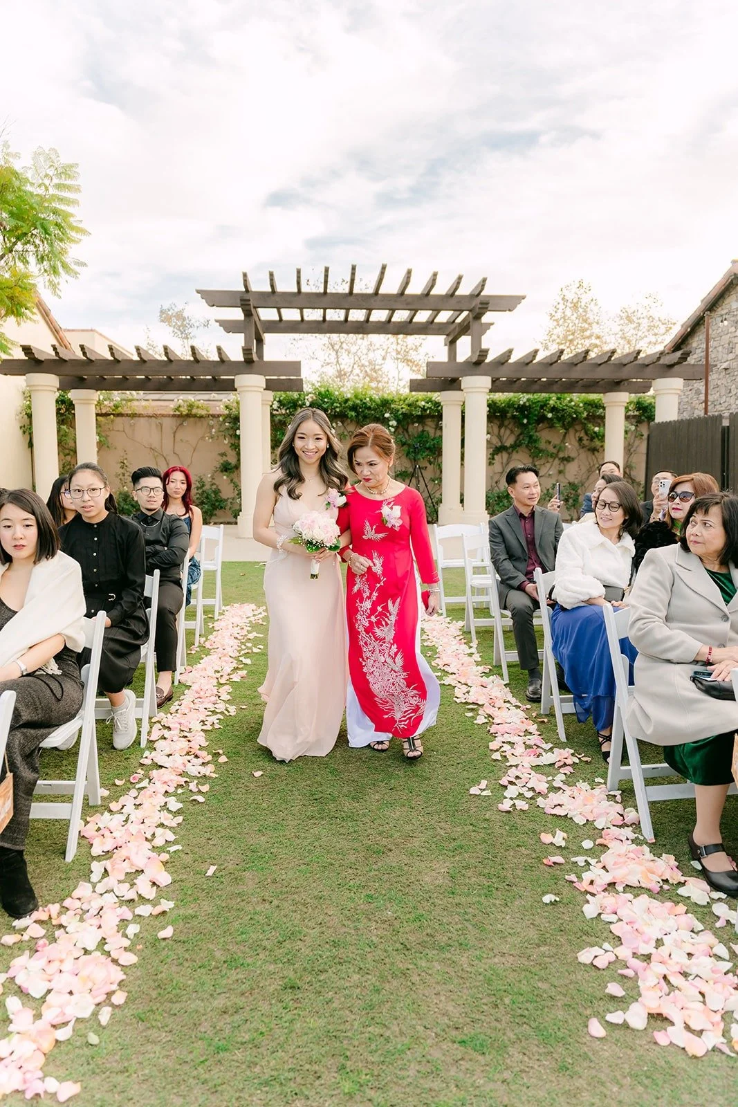 Family walking down the petal lined aisle