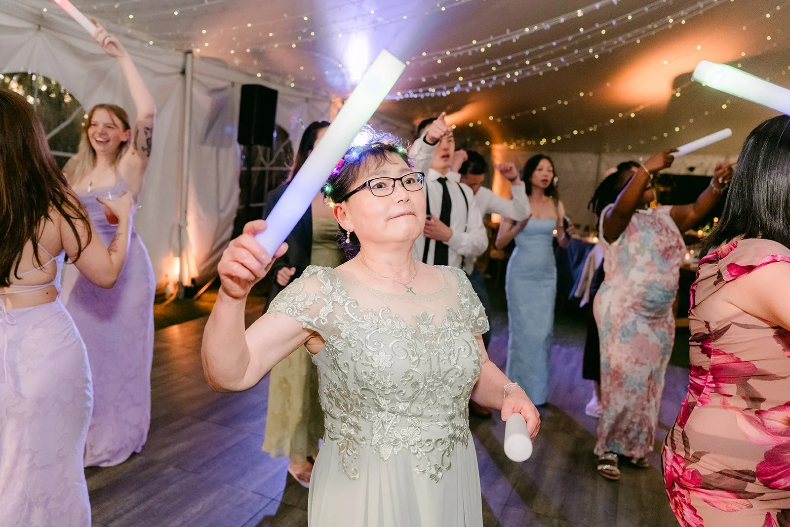 Guest waving a light-up foam stick on the dance floor
