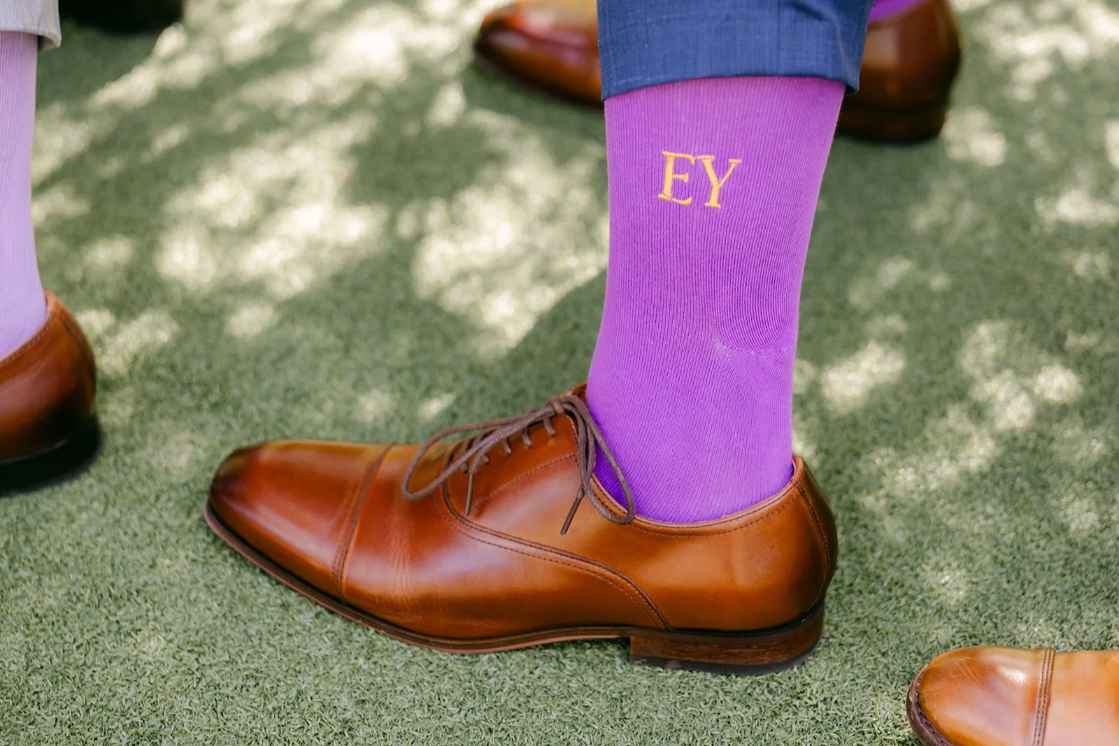 Elijah's purple socks embroidered with their initials.