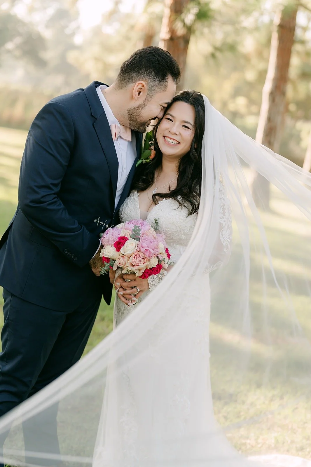 James kissing Amy's forehead under her flowing veil