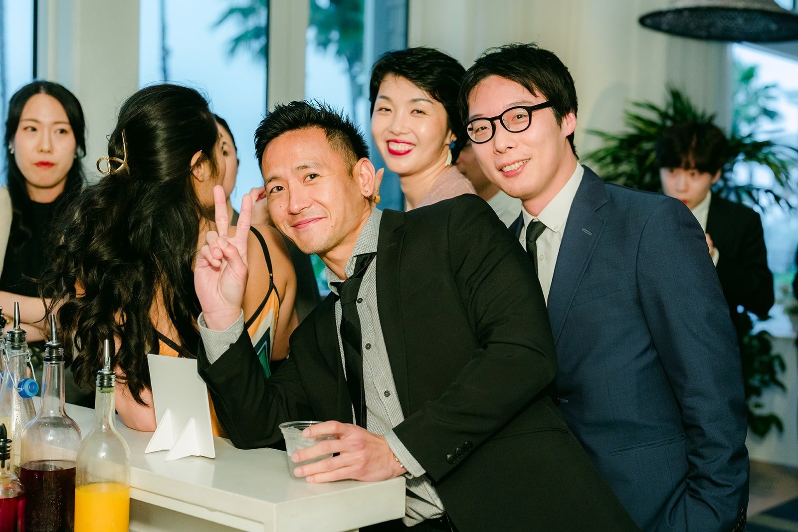 Friends crowding in for a selfie during cocktail hour, photographed by One and Only Production